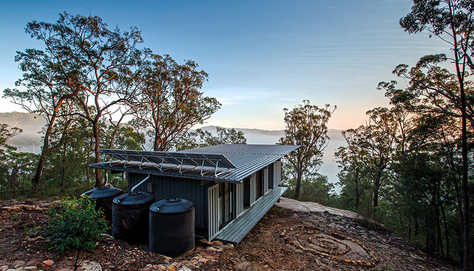 This bush retreat combines the brutal posturing of prosaic shipping containers with the refined elegance of a soaring lightweight roof made from COLORBOND® steel in LYSAGHT KLIP-LOK® 700 profile, in the colour Ironstone®