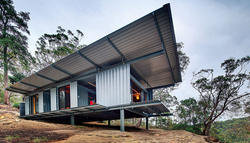 This bush retreat combines the brutal posturing of prosaic shipping containers with the refined elegance of a soaring lightweight roof made from COLORBOND® steel in LYSAGHT KLIP-LOK® 700 profile, in the colour Ironstone®