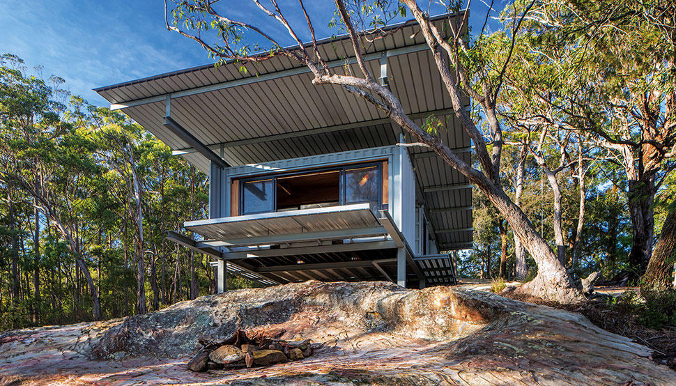 This bush retreat combines the brutal posturing of prosaic shipping containers with the refined elegance of a soaring lightweight roof made from COLORBOND® steel in LYSAGHT KLIP-LOK® 700 profile, in the colour Ironstone®
