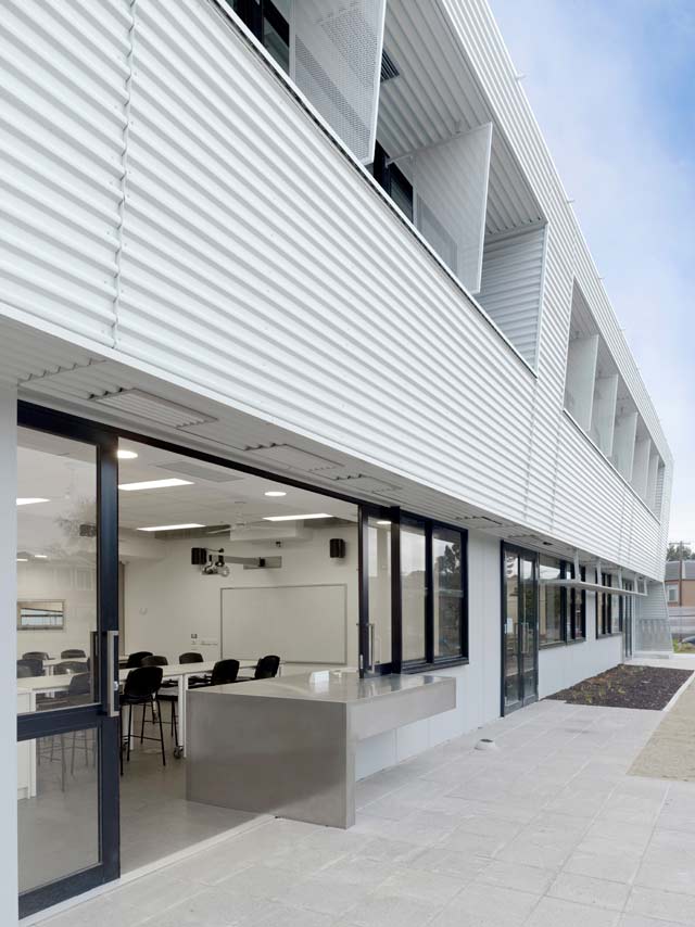 Dandenong High School is clad in Stramit Longspan® made from COLORBOND® steel in the lighter Shale Grey™ facing the sun, while the darker Night Sky® faces the shade.