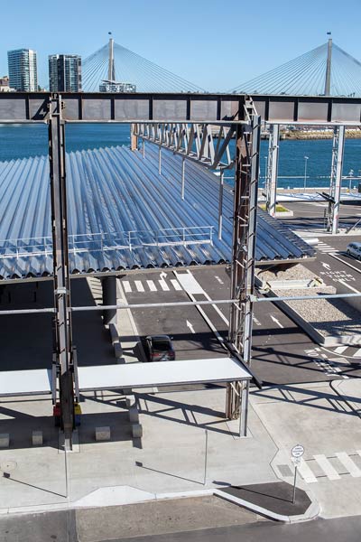 White Bay Cruise Terminal uses Fielders ARAMAX® profile aluminium roof; BlueScope steel plate used throughout, including to fabricate the long-span, curved roof purlins; LYSAGHT® purlins and girts