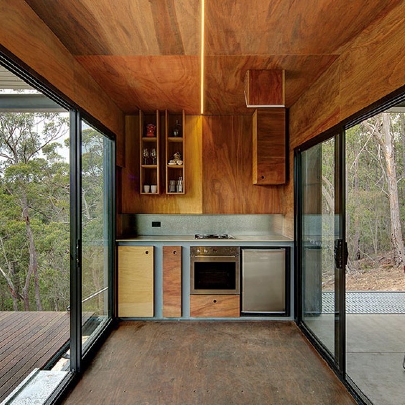 This bush retreat combines the brutal posturing of prosaic shipping containers with the refined elegance of a soaring lightweight roof made from COLORBOND® steel in LYSAGHT KLIP-LOK® 700 profile, in the colour Ironstone®