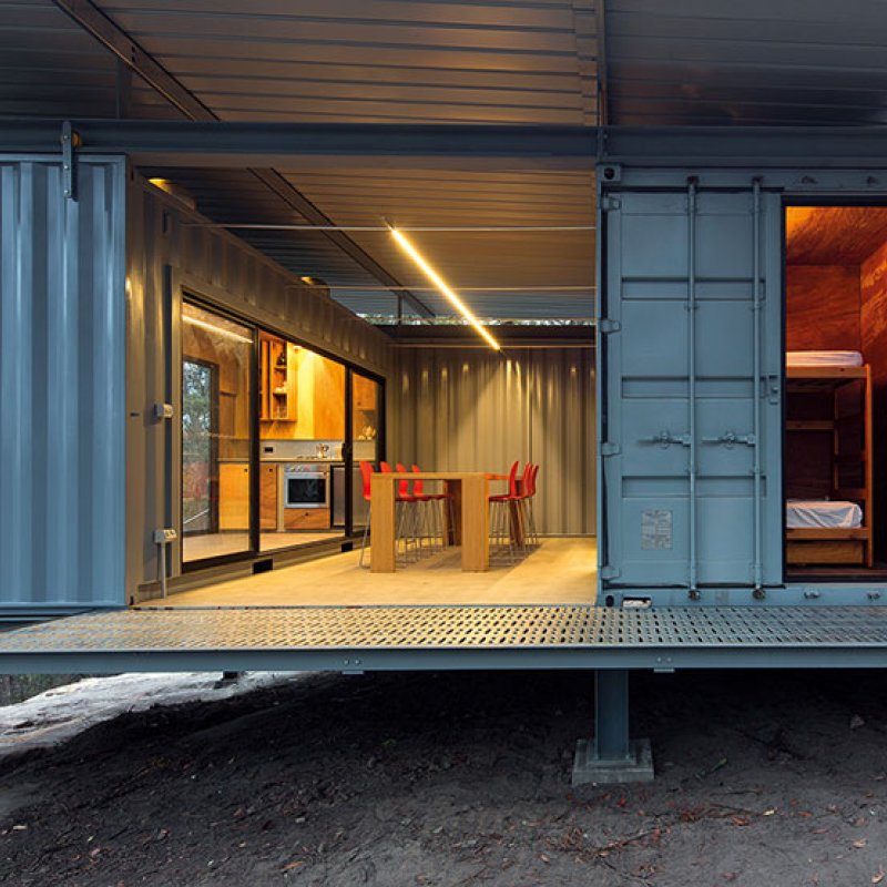 This bush retreat combines the brutal posturing of prosaic shipping containers with the refined elegance of a soaring lightweight roof made from COLORBOND® steel in LYSAGHT KLIP-LOK® 700 profile, in the colour Ironstone®