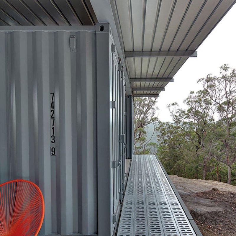 This bush retreat combines the brutal posturing of prosaic shipping containers with the refined elegance of a soaring lightweight roof made from COLORBOND® steel in LYSAGHT KLIP-LOK® 700 profile, in the colour Ironstone®