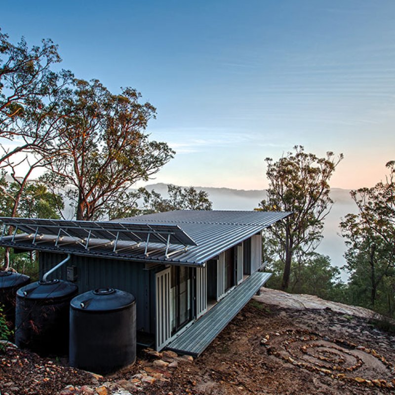 This bush retreat combines the brutal posturing of prosaic shipping containers with the refined elegance of a soaring lightweight roof made from COLORBOND® steel in LYSAGHT KLIP-LOK® 700 profile, in the colour Ironstone®