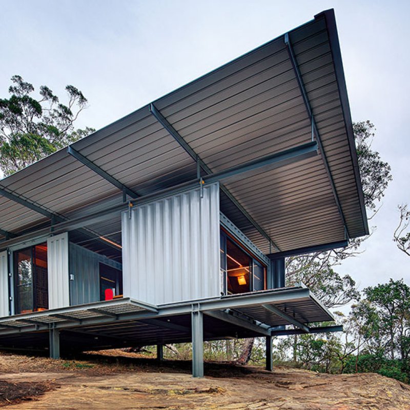 This bush retreat combines the brutal posturing of prosaic shipping containers with the refined elegance of a soaring lightweight roof made from COLORBOND® steel in LYSAGHT KLIP-LOK® 700 profile, in the colour Ironstone®
