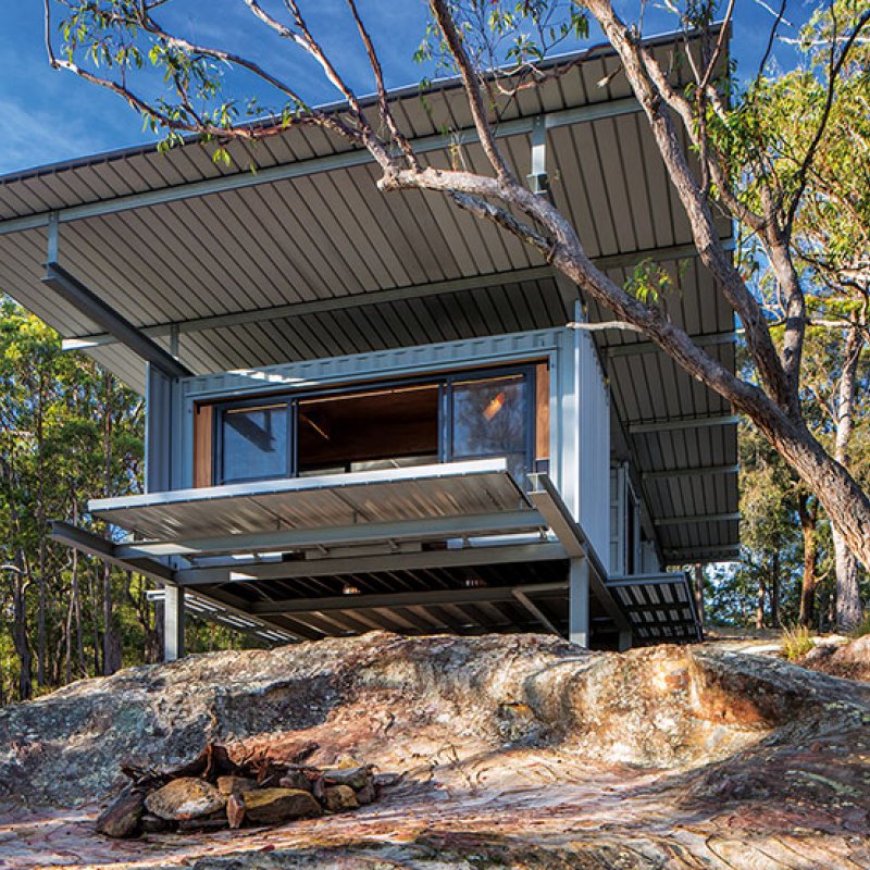 This bush retreat combines the brutal posturing of prosaic shipping containers with the refined elegance of a soaring lightweight roof made from COLORBOND® steel in LYSAGHT KLIP-LOK® 700 profile, in the colour Ironstone®