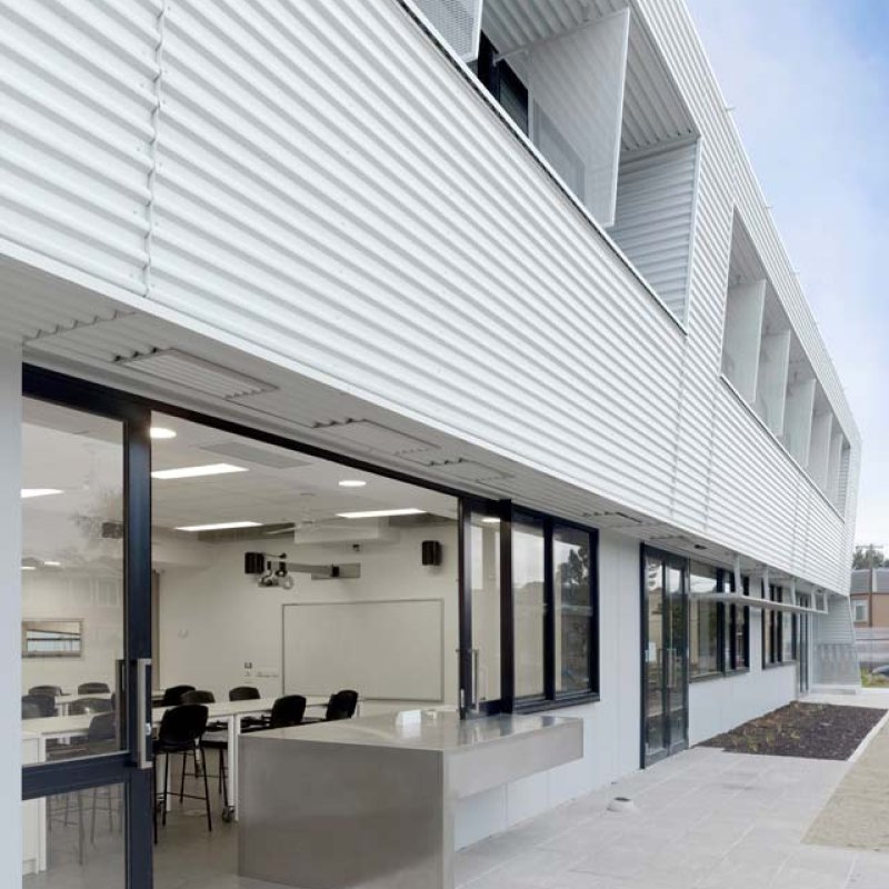 Dandenong High School is clad in Stramit Longspan® made from COLORBOND® steel in the lighter Shale Grey™ facing the sun, while the darker Night Sky® faces the shade.